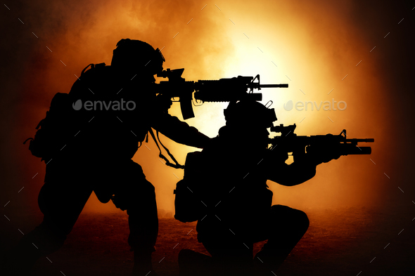 Two attacking soldiers surrounded flame and smoke Stock Photo by Getmilitaryphotos