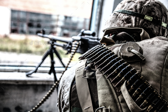 Commando soldier machine gunner firing from window - Stock Photo - Images