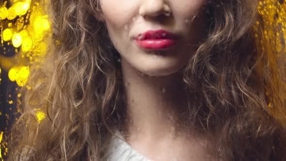 Young Beautiful Woman Looking out the Window alt