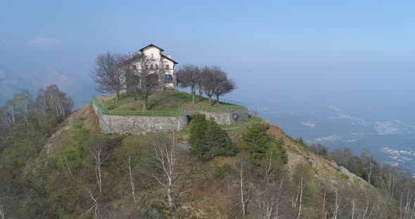 Aerial View of Mountain Peak During Autumn During Day with Building on Top alt