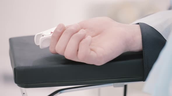 Human hand with a sensing device connected to it alt