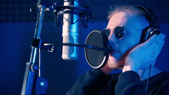 Male Rap Singer Sings Hip Hop in Microphone. Creation Song in Recording Studio alt