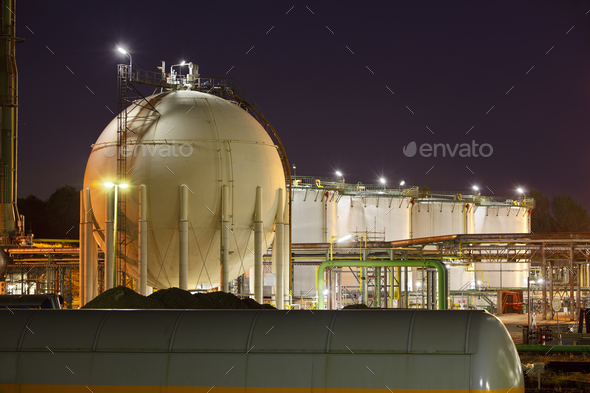 Oil And Gas Storage Tanks At Night Stock Photo by IndustryAndTravel