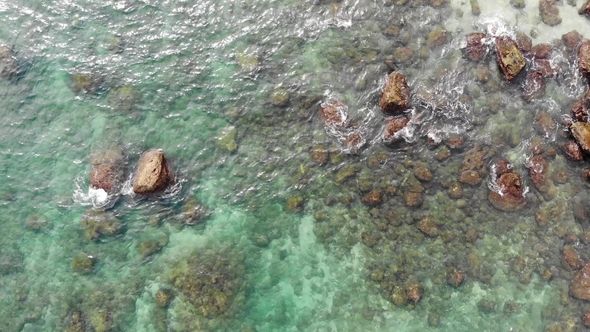 Aerial View Wave in the Ocean And Stones on a Clear Day