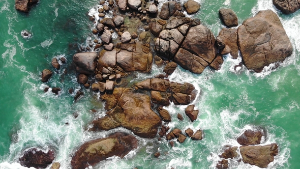 Top View Moving Up Away Ocean Blue Waves Crash Coastline Cliff