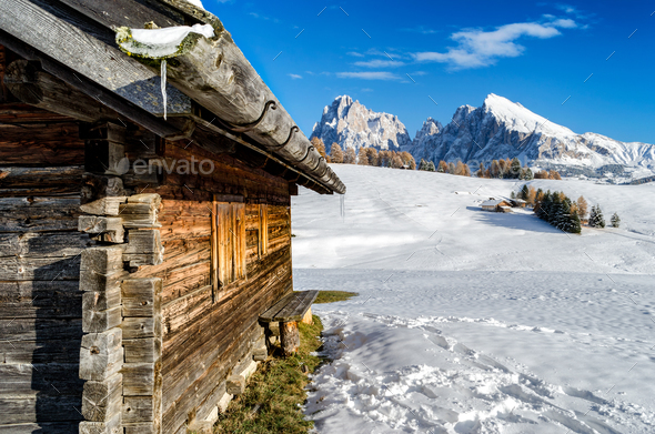 Wooden cabin in the snow with a view on the Dolomites - Stock Photo - Images