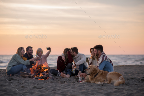 Friends having fun at beach on autumn day Stock Photo by dotshock | PhotoDune