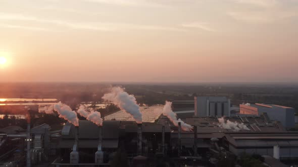 Aerial view Drone shot of flying around toxic chimneys tubing. Air Pollutants, Industrial zone