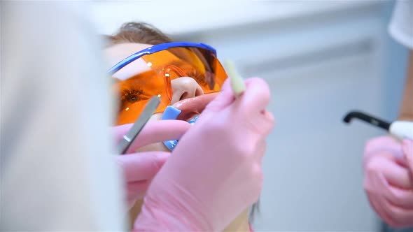Doctor Examines The Patient's Teeth Before Whitening Procedure