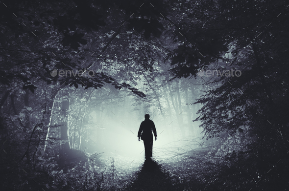 Silhouette of man in mysterious light in haunted woods Stock Photo by ... Silhouette Man Walking Tunnel