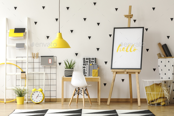 White Chair At Desk Next To Easel With Poster In Geometric Child