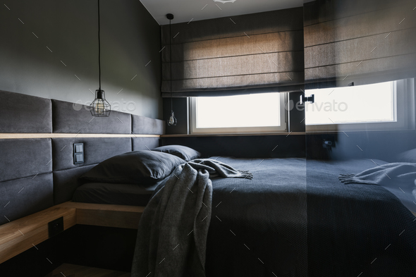 Cozy Dark Bedroom Interior With Gray Sheets And Blanket And A F