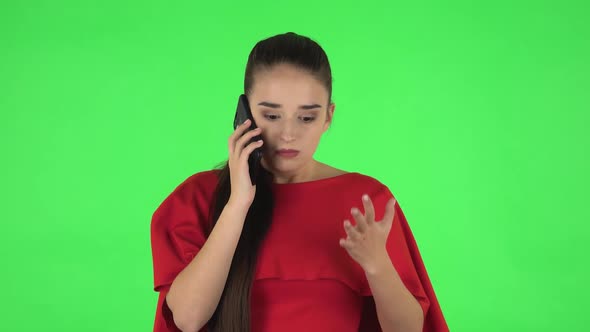 Portrait of Pretty Young Woman Is Angrily Speaking on the Phone, Proving Something alt