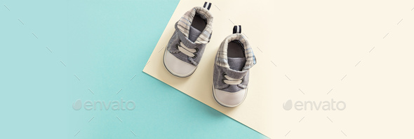 Baby boy shoes on pastel colors background, banner Stock Photo by rawf8