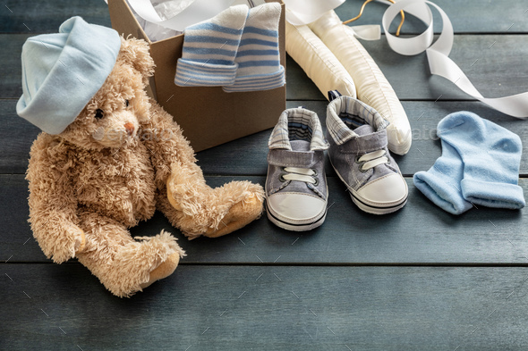 Pair Of Small Baby Socks On Blue Background With Copy Space For