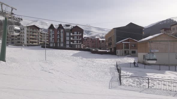 Flying over rope-way with gondolas at mountain resort Crystal Park in Bakuriani. Snowy winter day. alt