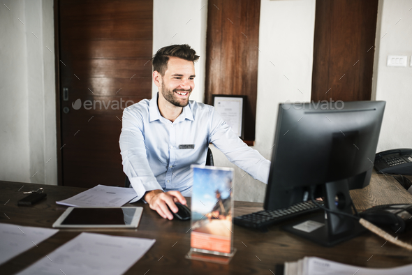 Receptionist working at the front desk - Stock Photo - Images