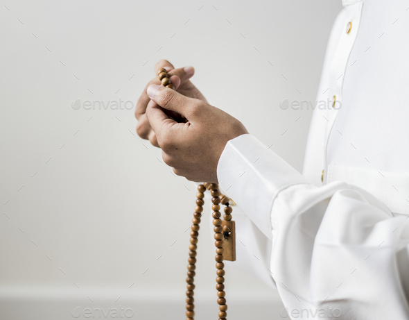 Muslim man using misbaha to keep track of counting in tasbih Stock Photo by Rawpixel