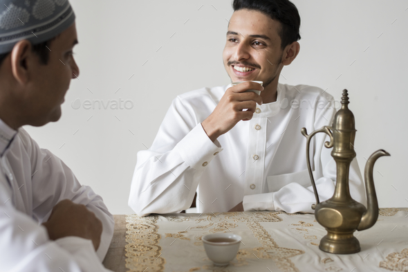 Muslim men having a cup of tea - Stock Photo - Images