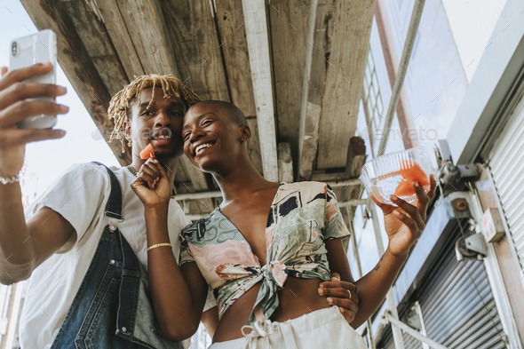 Couple snacking on fruit in the summer - Stock Photo - Images