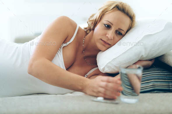 Picture of pregnant woman taking medication pills - Stock Photo - Images