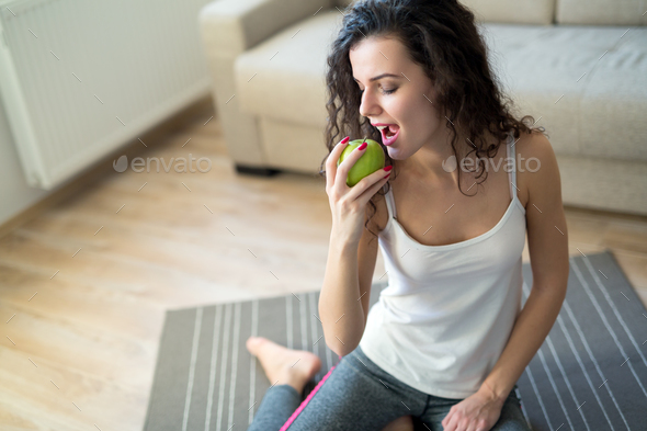 Fitness woman eating healthy food after workout Stock Photo by nd3000