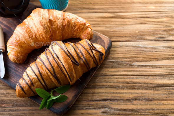 Two Croissants On The Street In Croissant Cafe Inscripton On Cup Croissant Cafe Stock Photo By Lyulkamazur