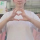 Unrecognizable Woman Making Heart with Hands As People with Anti-homophobia Banners Yelling at the - VideoHive Item for Sale