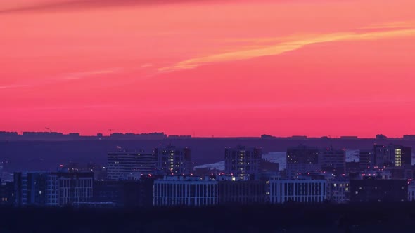 Night urban landscape with lights coming on in city houses, time lapse. Multi-storey buildings after alt