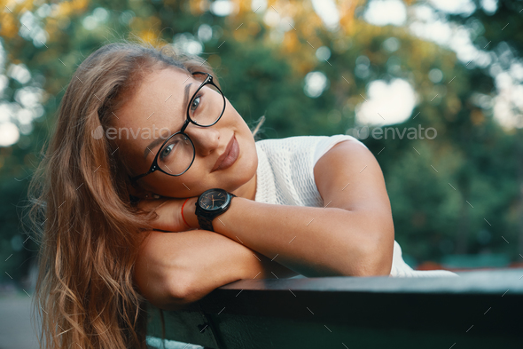 Positive woman having a break from city noise and work while bre Stock Photo by arthurhidden