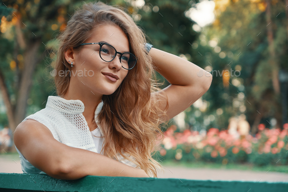 Positive woman having a break from city noise and work while bre Stock Photo by arthurhidden