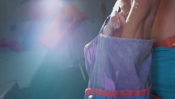 A Young Handsome Man Uses Magnesia for His Hands alt