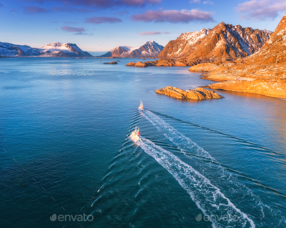 Aerial view of fishing boats, rocks in the blue sea - Stock Photo - Images
