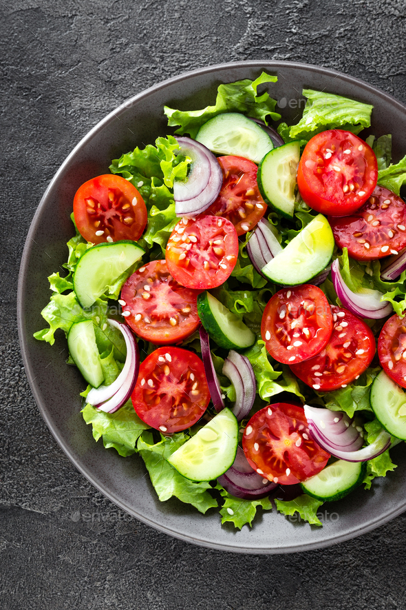 Salad. Fresh vegetable salad with tomato, cucumber, lettuce and red ...