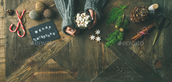 Flat-lay of greeting card, glittering toy, woman's hands holding mug - Stock Photo - Images