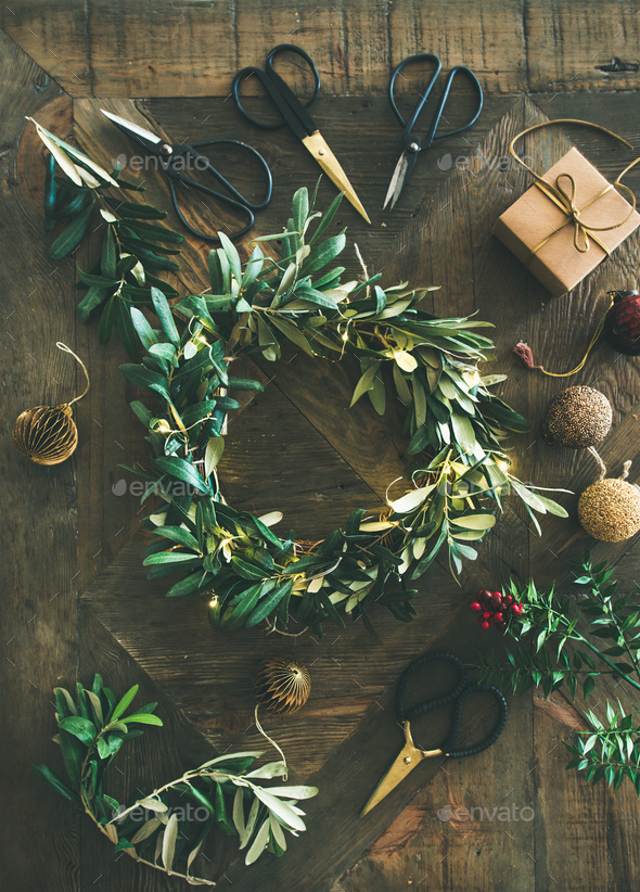 Flat-lay of Christmas decoration toys and wreath over wooden background - Stock Photo - Images