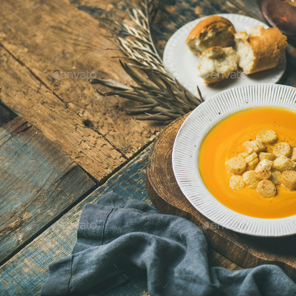 Fall pumpkin cream soup with croutons and seeds, square crop - Stock Photo - Images