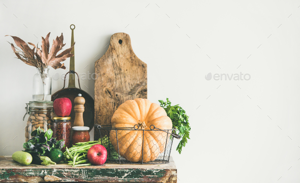 Autumn food ingredients and utensils over wooden cupboard chest Stock Photo by sonyakamoz