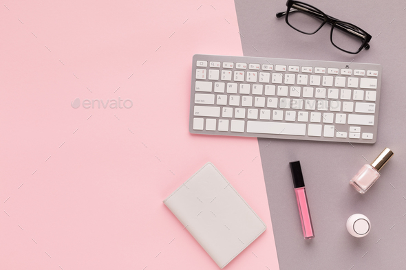 Working space with keyboard on pink background Stock Photo by Prostock-studio