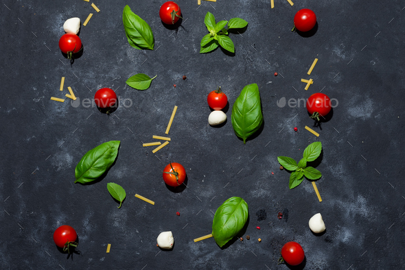 Mozzarella cheese, basil and tomato cherry on slate stone board, copy space and top view. - Stock Photo - Images