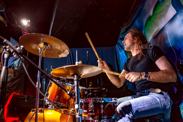 Drummer playing on drum set on stage. Stock Photo by cookelma | PhotoDune