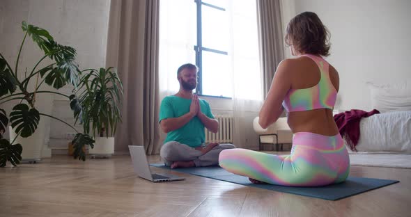 Couple Meditating at Home with Online Yoga Tutorial alt