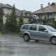 Raining on the Street While Cars are Passing