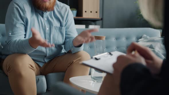 Low Shot of Male Hands Gesturing While Person Talking to Therapist in Office alt