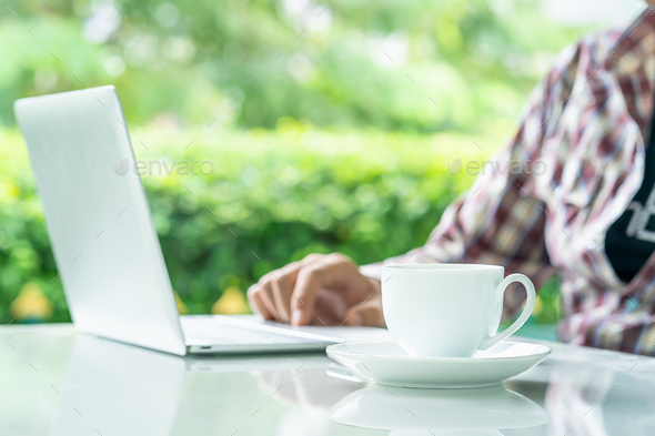 Laptop computer and cup of coffee on the table _ - Stock Photo - Images