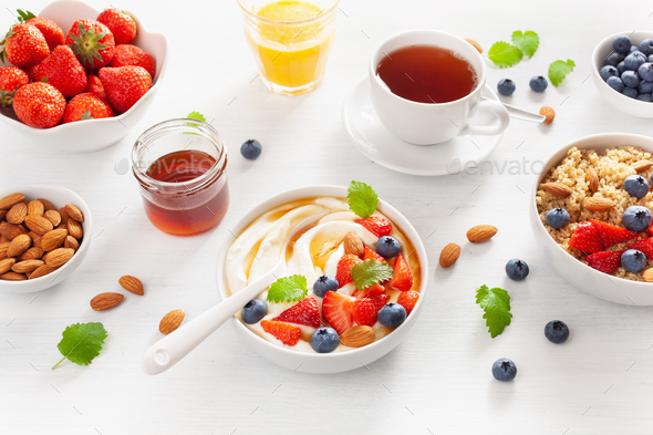 yogurt with strawberry blueberry honey almond and quinoa for bre Stock Photo by duskbabe