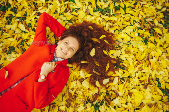 Young beautiful lady surrounded autumn leaves Stock Photo by arthurhidden