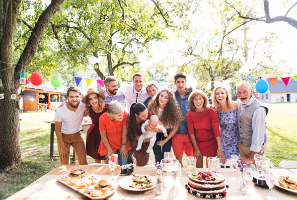 Family celebration or a garden party outside in the backyard. Stock Photo by halfpoint