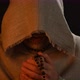 Monk in haircloth cowl robe praying in candlelight - VideoHive Item for Sale