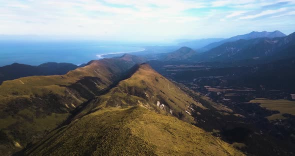 Aerial reveal shot of beautiful misty Mt Alexander, Seaward Kaikoura Range. Kaikoura. alt